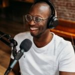 Podcaster sitting at a microphone