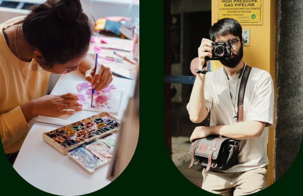A woman painting with water colors at her desk and a man holding a camera to his eye